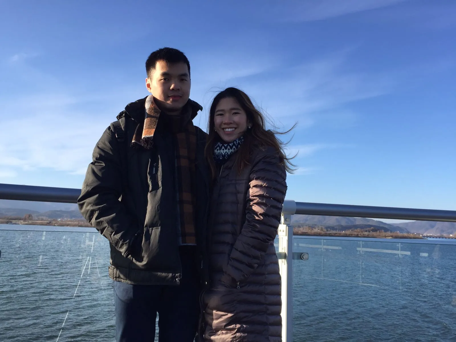 Nicholas and his wife at Soyanggang Skywalk with the water and mountains behind them