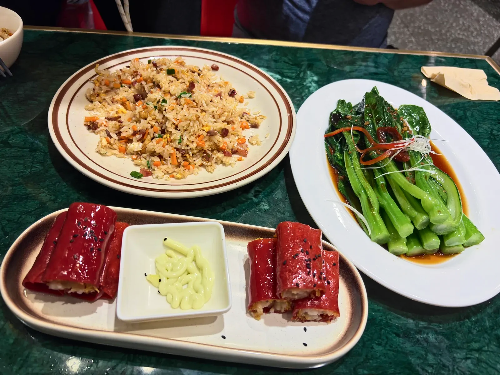 Dinner of red-glazed rolls with a creamy dip, fried rice and greens
