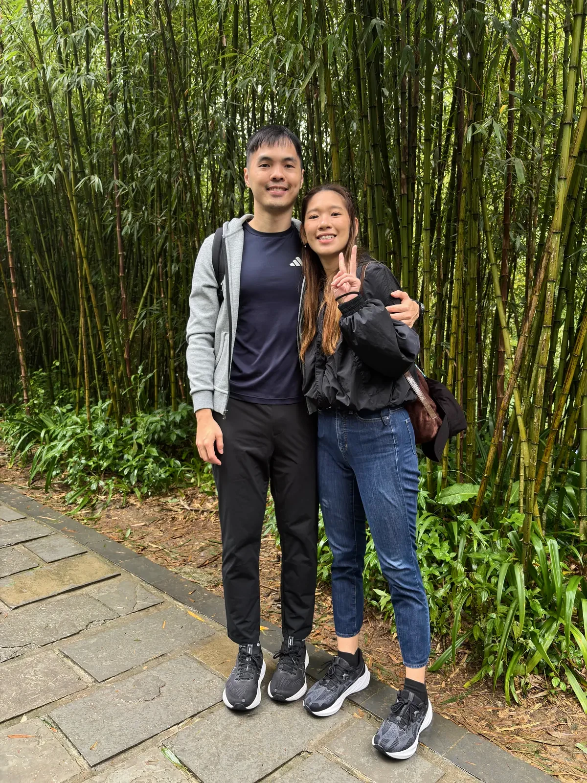 Couple on a bamboo-lined path at Dujiangyan Panda Base