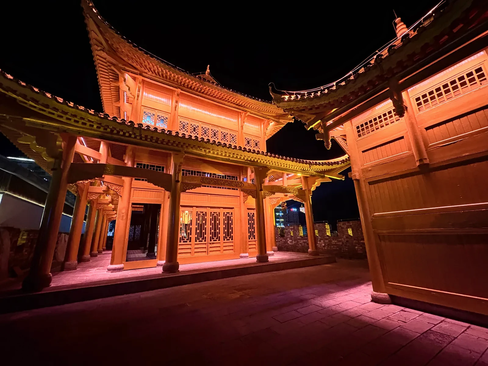 Traditional pavilion in Dayong Ancient City lit in amber at night