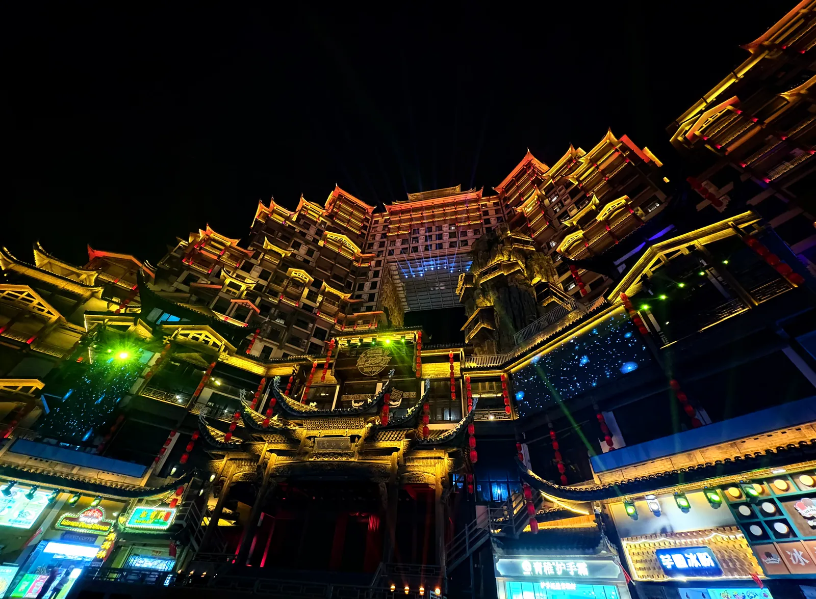 72 Wonder Tower glowing in green and gold at night