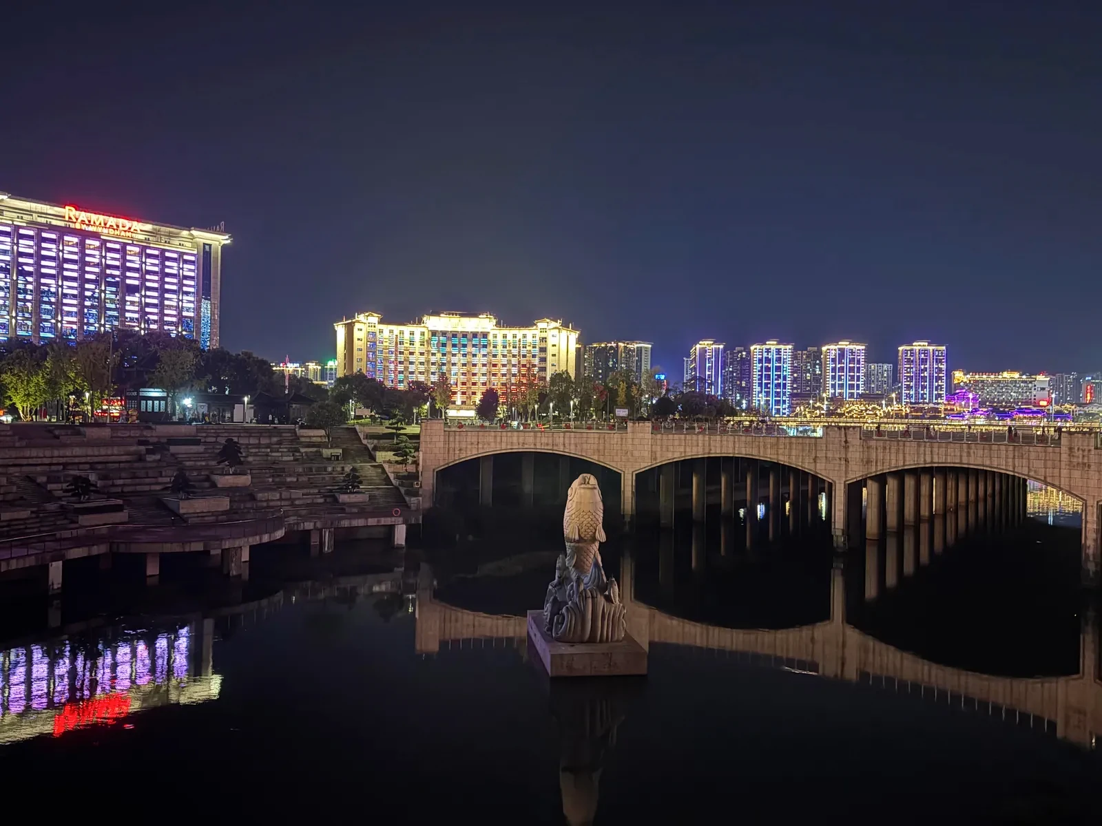 Zhangjiajie riverfront and bridge reflected in the water at night