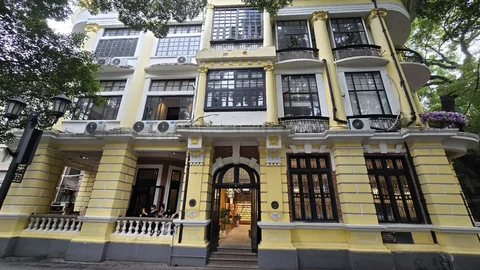 Yellow colonial-era building among the trees on Shamian Island