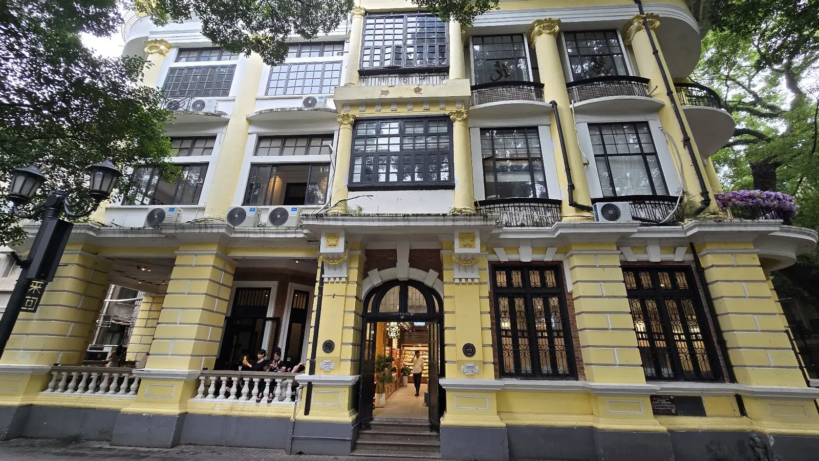 Yellow colonial-era building among the trees on Shamian Island