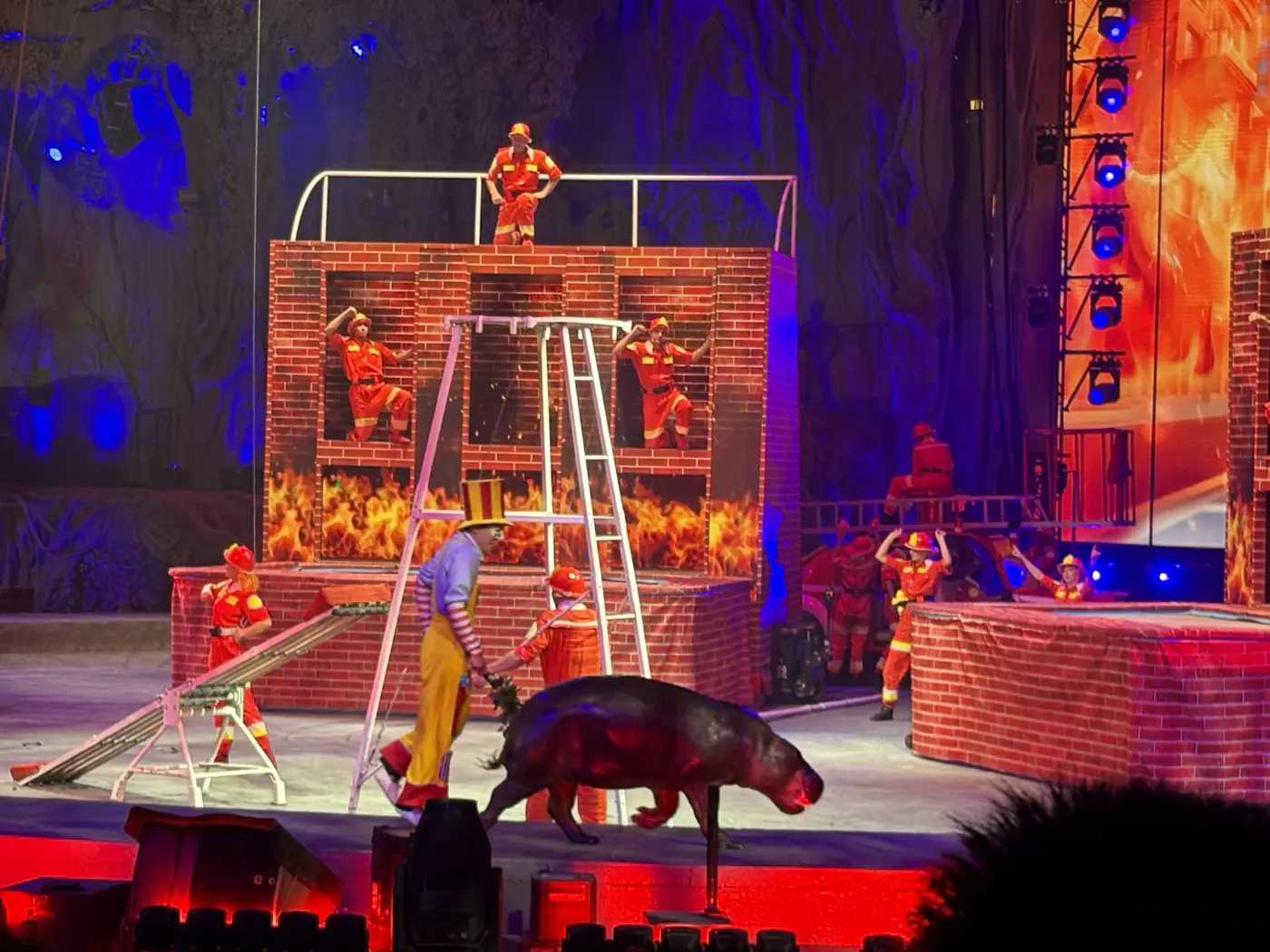 Performers and a hippopotamus on stage at Chimelong International Circus