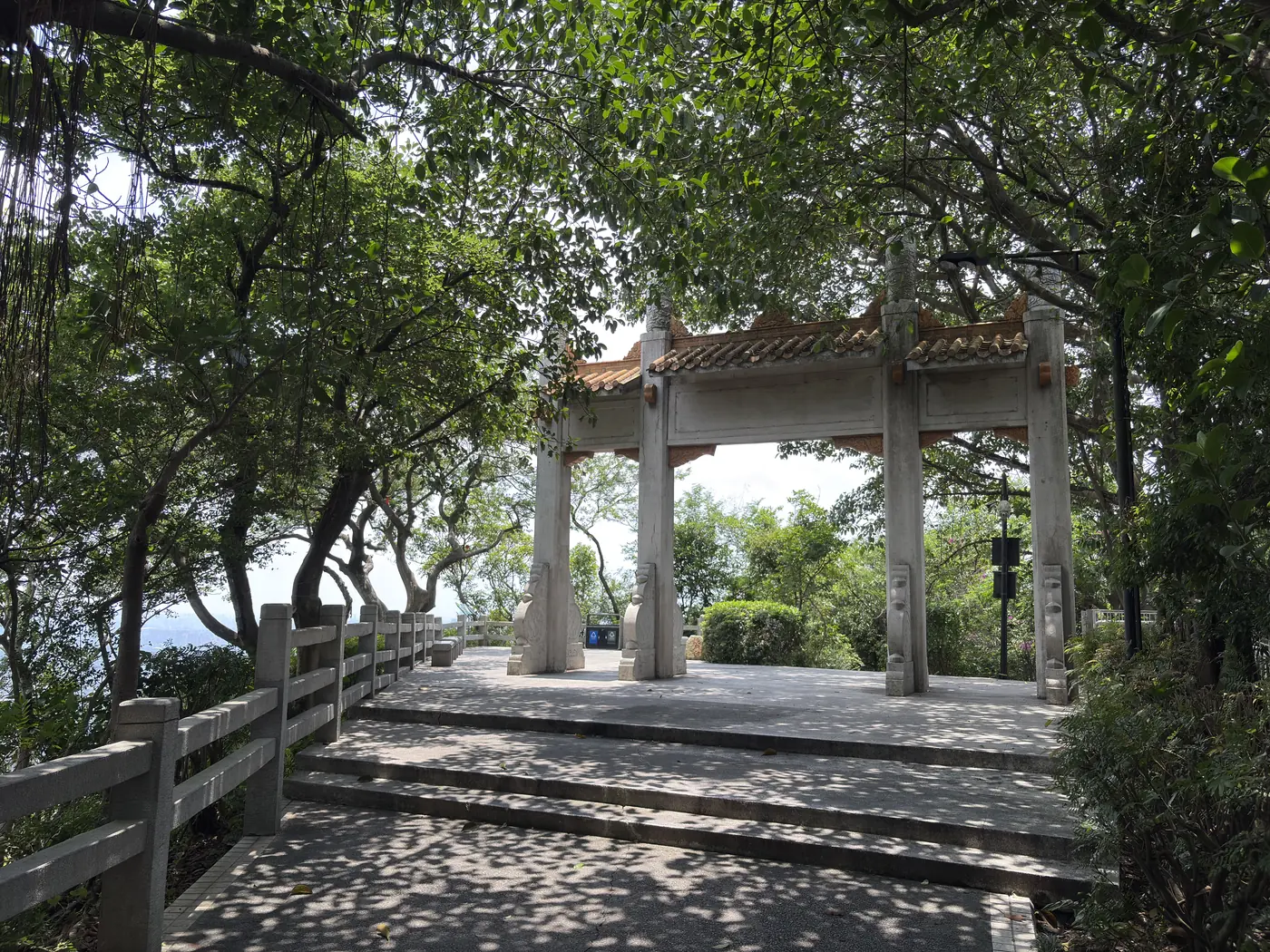 Stone pavilion shaded by trees on Baiyun Mountain