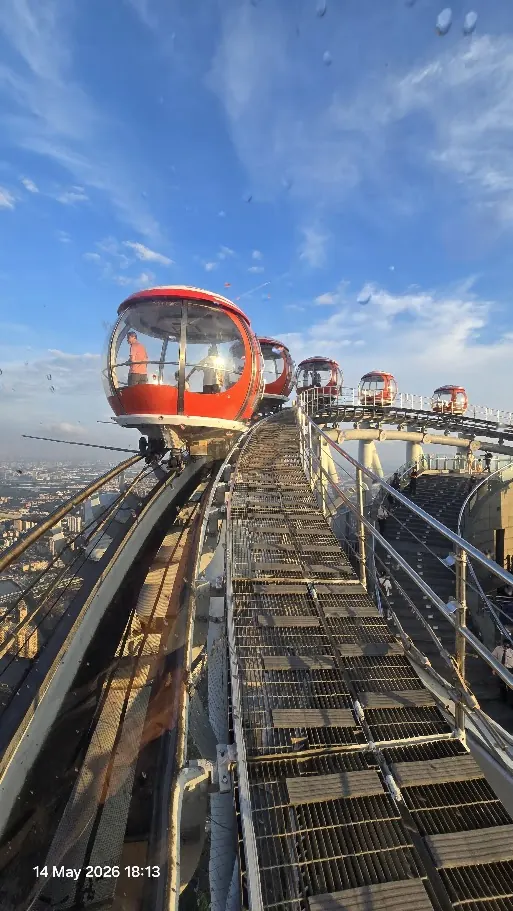 Red Bubble Tram cabins circling the rooftop of Canton Tower