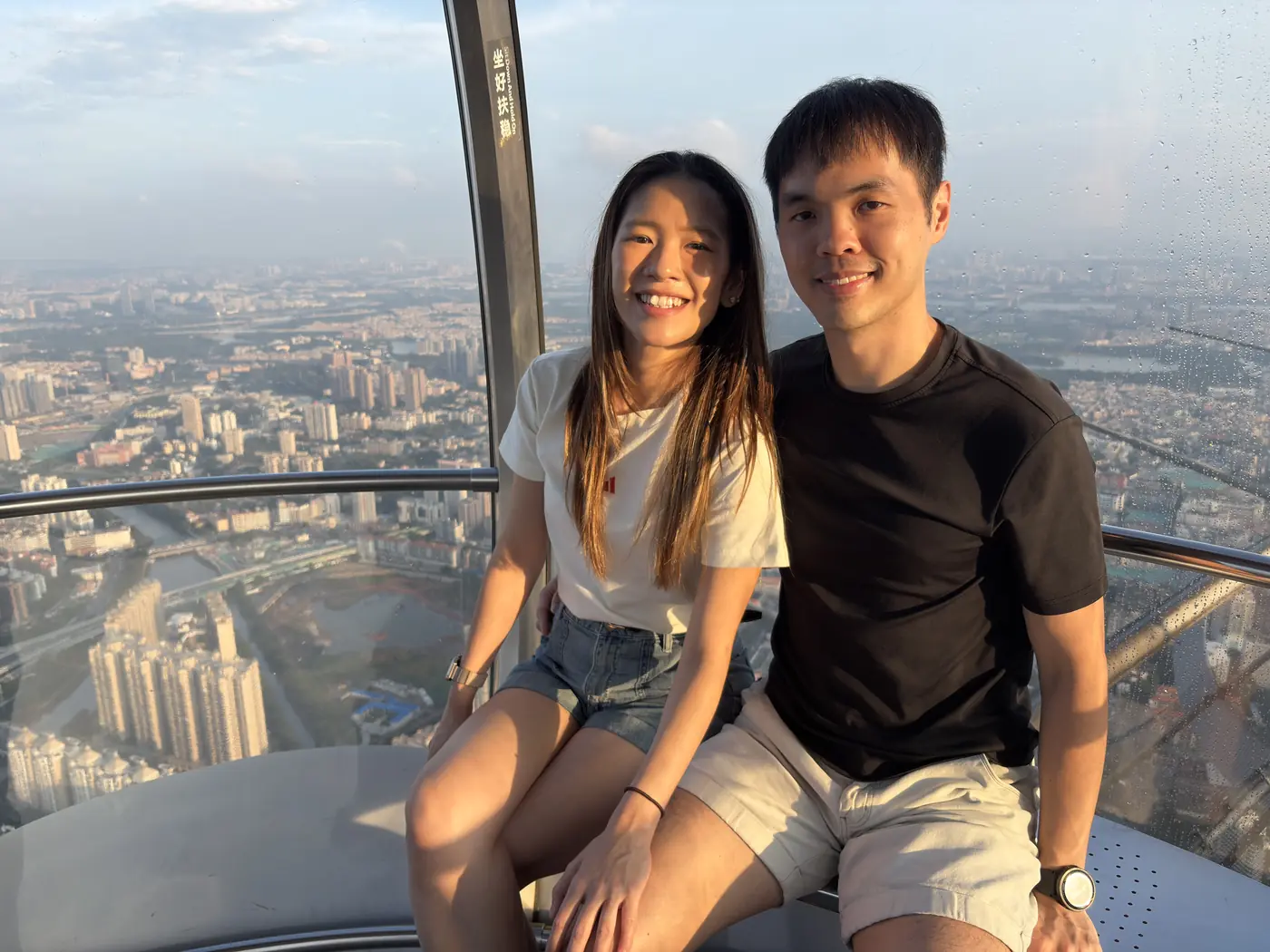 Couple seated by the windows near the top of Canton Tower